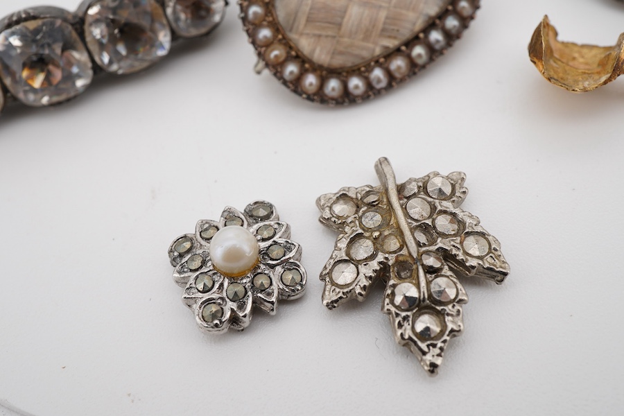 Assorted jewellery including a 19th century mourning brooch with plaited hair and split pearl set border, 22mm, a yellow metal mounted tooth, three marcasite set items and a paste set brooch.